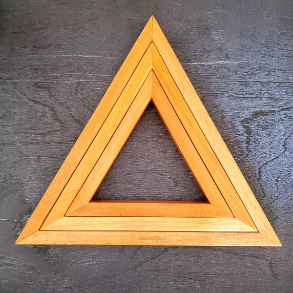 A set of three wooden triangles to hang on the living /dining or bed room wall. The set comes in three different sizes of triangles which could be arranged in multiple ways to suit your style. Made out of pinewood or mahogany gives the décor a beautiful color, and will go well on the walls that is either painted with light colors or dark colors. Triangle is the most significant, because of the inherent power of its form. There are 3 in the set and as number 3 is the most significant of all the numbers.