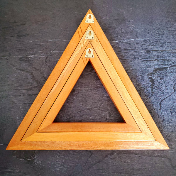 A set of three wooden triangles to hang on the living /dining or bed room wall. The set comes in three different sizes of triangles which could be arranged in multiple ways to suit your style. Made out of pinewood or mahogany gives the décor a beautiful color, and will go well on the walls that is either painted with light colors or dark colors. Triangle is the most significant, because of the inherent power of its form. There are 3 in the set and as number 3 is the most significant of all the numbers.